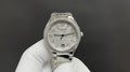 Patek Philippe watch with silver metal bracelet, jeweled bezel, white dial
