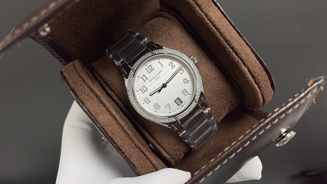 Patek Philippe watch on brown leather strap with silver case and white dial