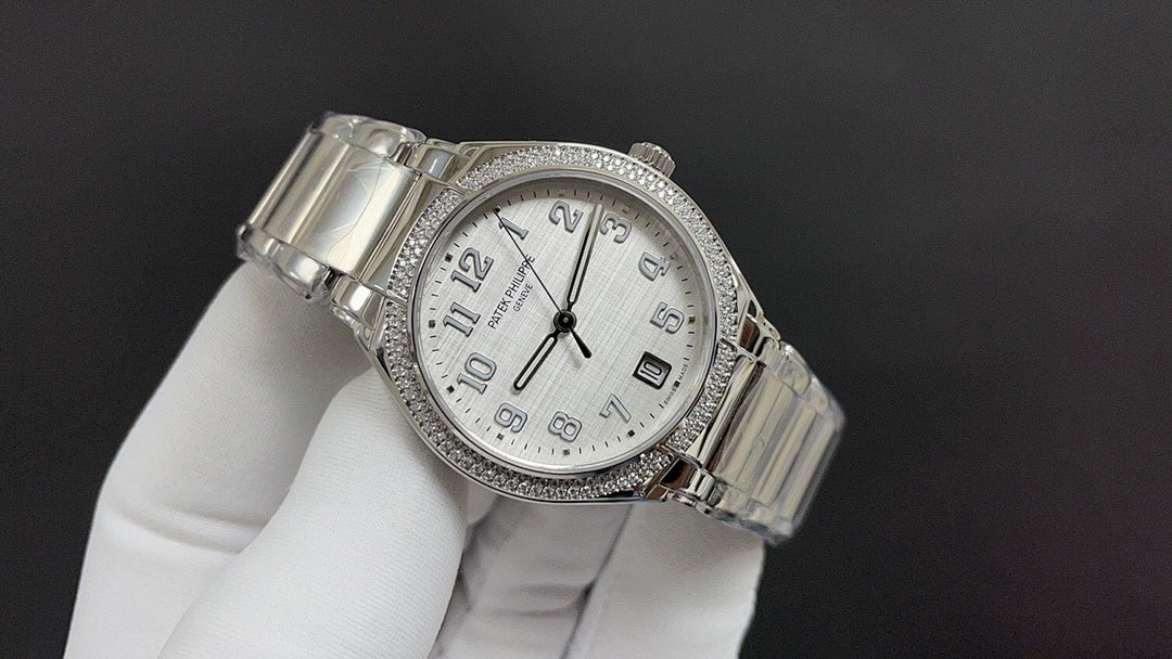 Patek Philippe watch angled view with silver metal bracelet and white dial