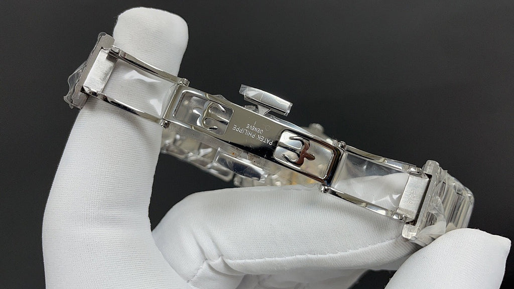 Silver metal wristwatch bracelet with clasp held in white gloves