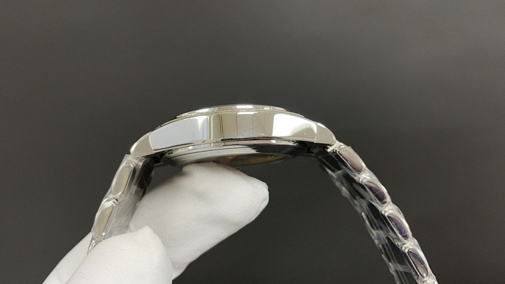 Silver wristwatch case top and bezel with clear strap links on glove hand