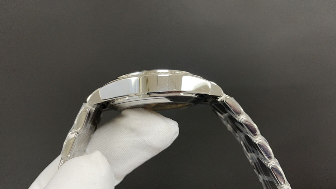 Silver wristwatch case top and bezel with clear strap links on glove hand