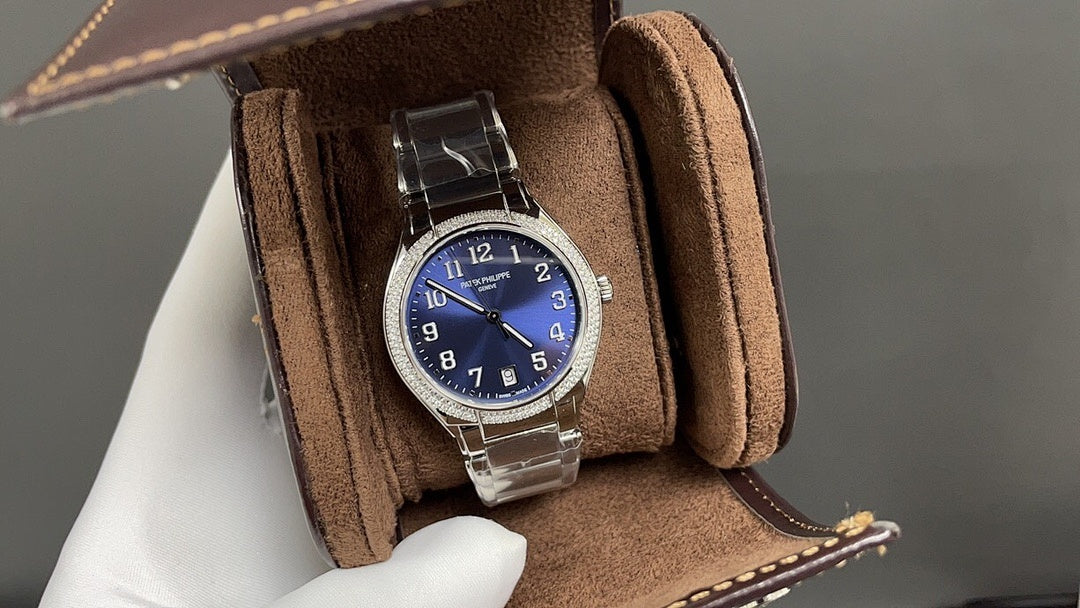 Silver wristwatch with blue dial on brown suede watch box