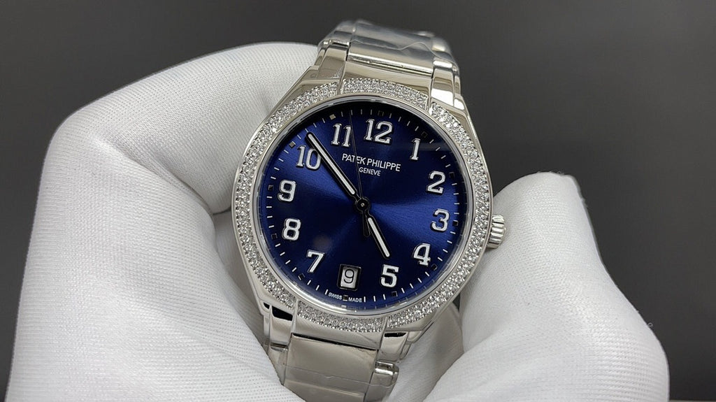Silver wristwatch with blue dial and diamond bezel on metal bracelet