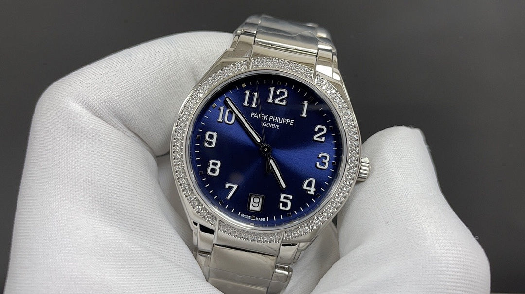 Silver wristwatch with blue dial and diamond bezel on metal bracelet