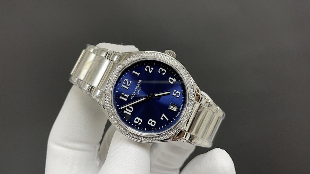 Blue-dial silver wristwatch angled view with diamond bezel on metal bracelet