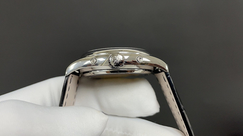 Patek Philippe wristwatch caseback view with crown and lugs, polished silver-tone, black strap