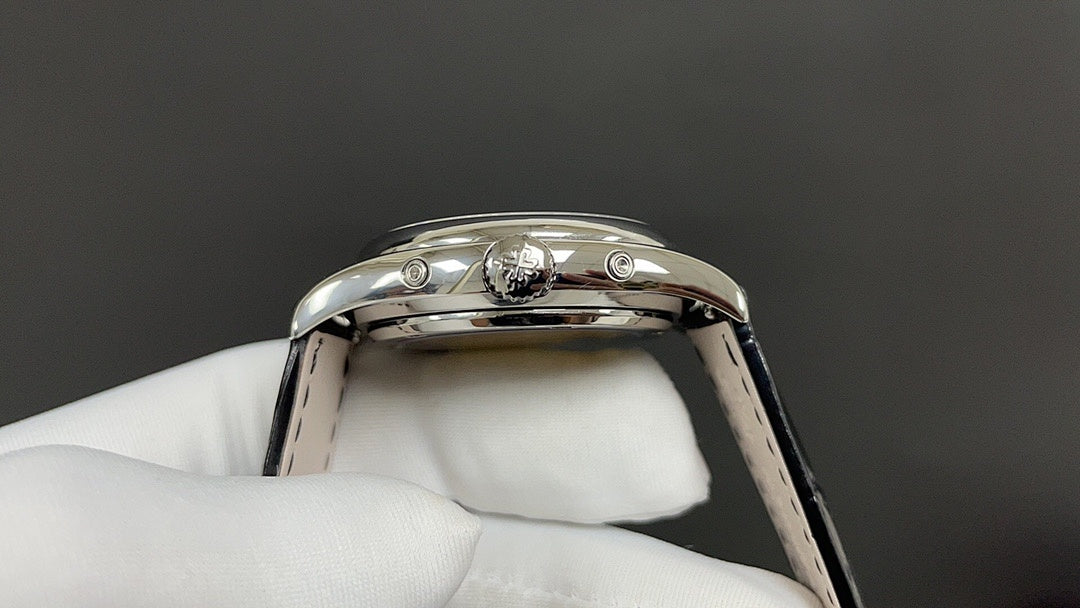 Patek Philippe wristwatch caseback view with crown and lugs, polished silver-tone, black strap