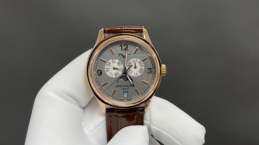 Gold-tone wristwatch with silver dial, brown leather strap, three subdials