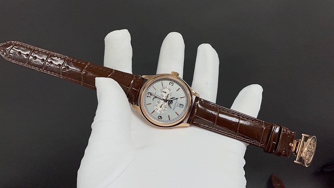 Brown leather strap wristwatch on glove, gold-tone case and light dial
