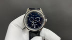 Patek Philippe wristwatch with blue dial and black leather strap