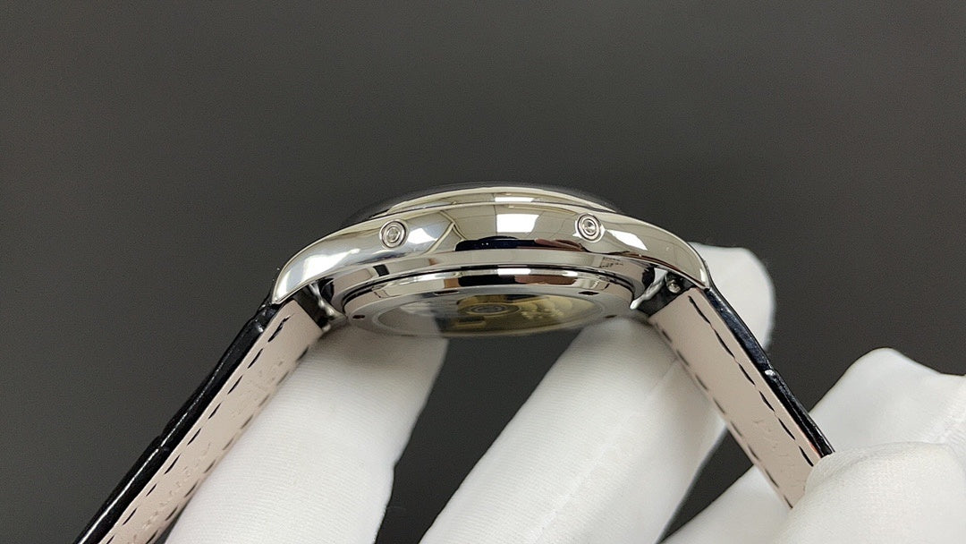 Wristwatch stainless steel case side with crown and black leather strap