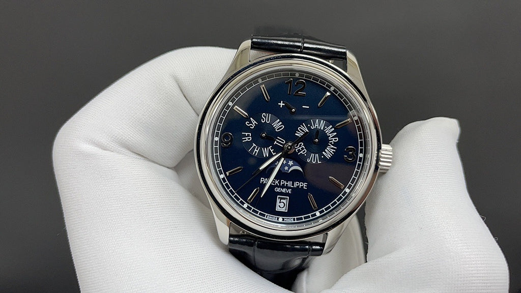 Wristwatch with blue dial, Roman numerals, and black leather strap