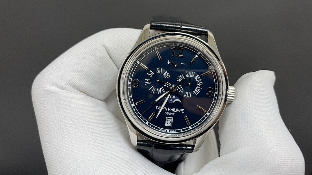 Wristwatch with blue dial, Roman numerals, and black leather strap