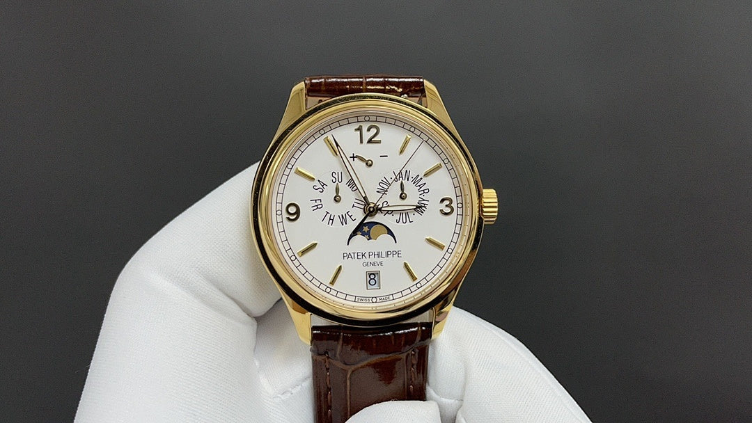Patek Philippe watch with gold case, white dial, and brown leather strap.