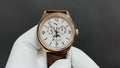 Patek Philippe wristwatch, gold-tone case, white dial, brown leather strap