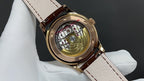 Patek Philippe wristwatch, gold-tone case with visible mechanical movement