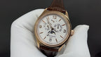 Patek Philippe wristwatch, gold-tone case, white dial, brown leather strap