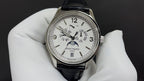 Patek Philippe watch front with white dial, Arabic numerals, black leather strap