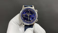 Patek Philippe watch with blue starry dial, silver bezel, and blue leather strap