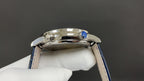 Patek Philippe watch top view with blue crown detail and polished metal case