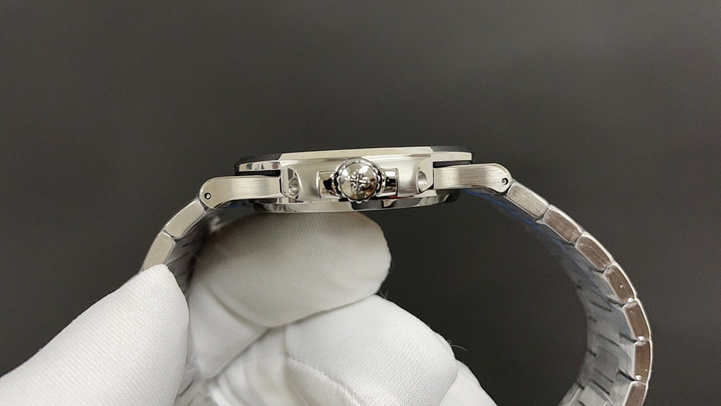 Stainless steel watch case side view with crown and links, underside detail