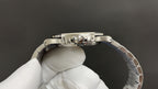 Stainless steel watch case side view with crown and links, underside detail