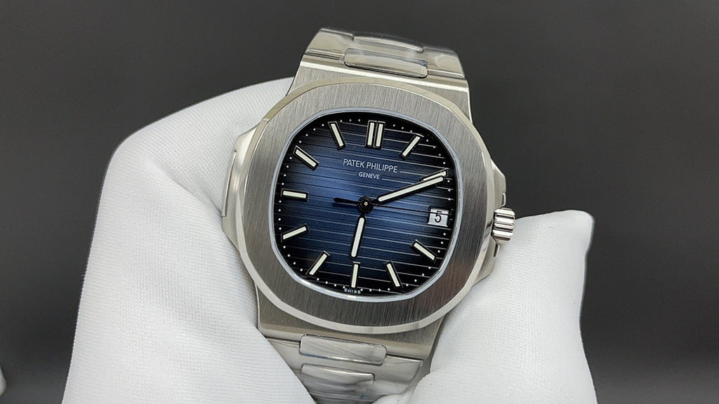 Stainless steel wristwatch with blue dial, baton markers, and date at 3