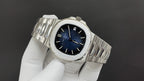 Stainless steel wristwatch with blue dial and metal bracelet from side angle