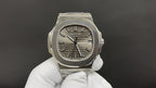 Patek Philippe wristwatch with steel case, sunburst dial, and black baton hour markers