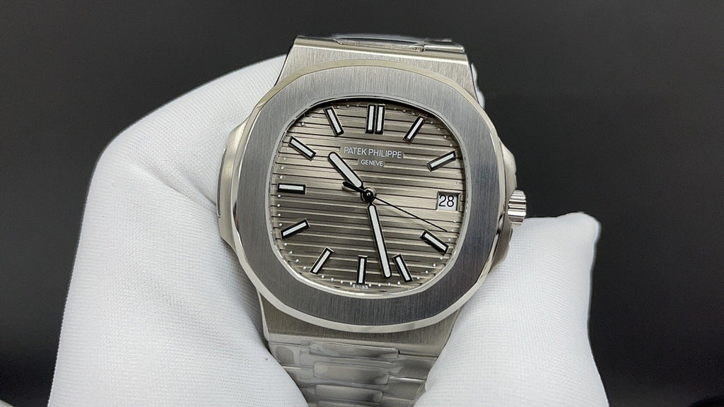 Patek Philippe wristwatch with steel bracelet, sunburst dial, and three-hand layout