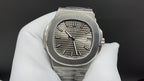 Patek Philippe wristwatch with steel bracelet, sunburst dial, and three-hand layout