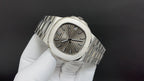 Patek Philippe wristwatch angled view with steel bracelet and sunburst dial