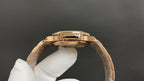 Patek Philippe gold-tone watch with linked bracelet and rounded case side profile.