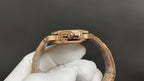 Patek Philippe gold-tone watch with crown and case top detail on linked bracelet.