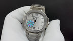 Silver metal wristwatch with white dial, jeweled bezel, and rainbow center