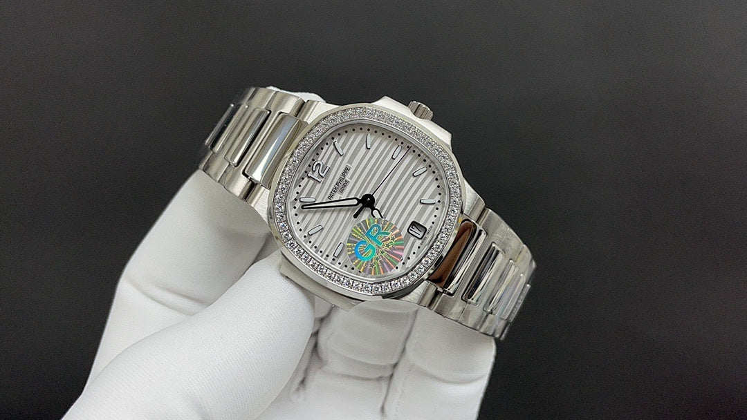 Silver metal wristwatch with white dial and rainbow center, angled side view