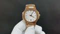 Gold-tone Patek Philippe wristwatch with white dial and three-hand display