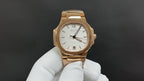 Gold-tone Patek Philippe wristwatch with white dial and three-hand display