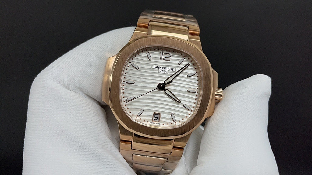 Gold-tone Patek Philippe wristwatch with white dial and baton-style hour markers