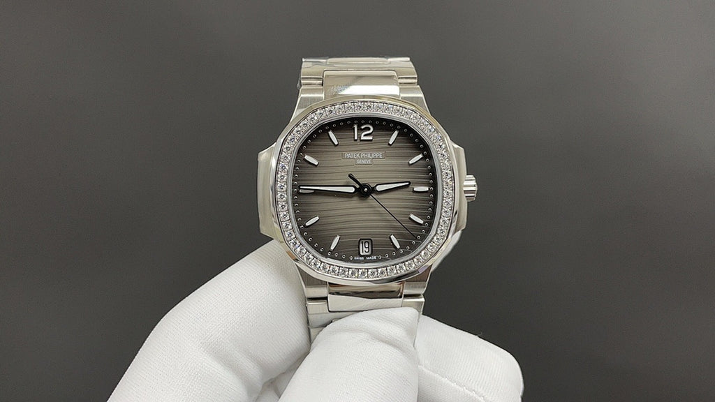 Stainless steel wristwatch with dark dial, jeweled bezel, metal bracelet, round crown