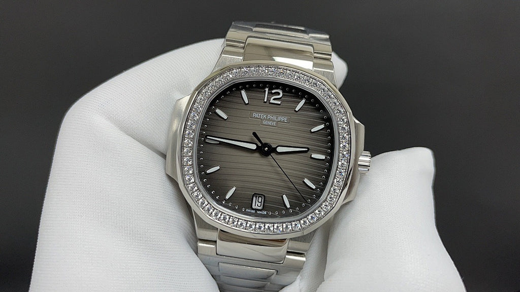 Stainless steel wristwatch with dark dial, diamond-studded bezel, metal bracelet