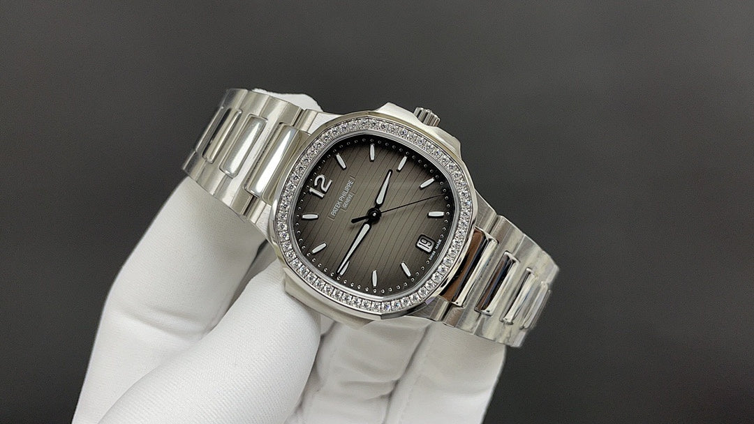 Stainless steel wristwatch angled view with dark dial, jeweled bezel, metal bracelet