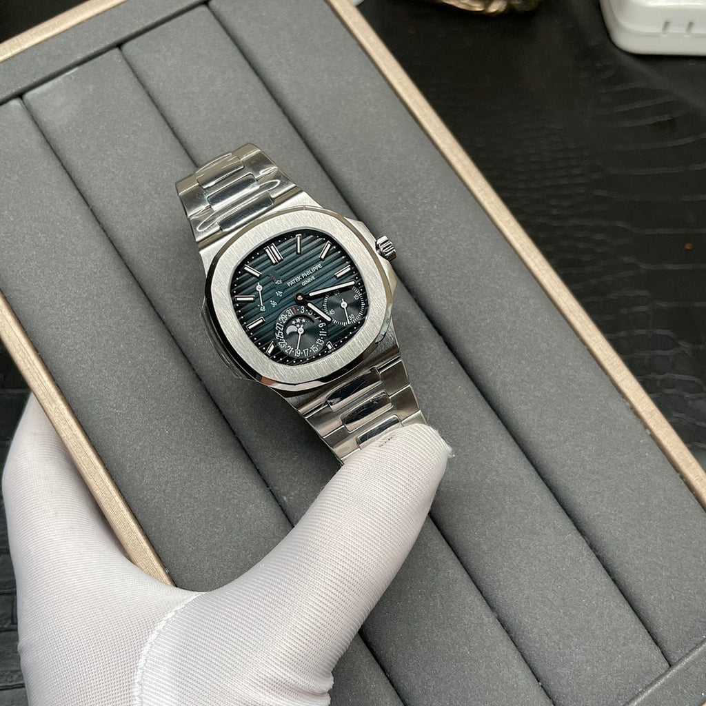 Stainless steel Patek Philippe watch with black dial, teal accents, and metal bracelet