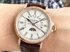 Patek Philippe watch on wrist with brown leather strap and white dial, gold-tone bezel