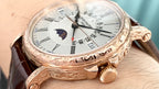 Patek Philippe watch side view with brown leather strap, white dial, and gold-tone crown