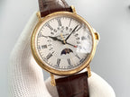 Gold wristwatch with brown leather strap, white dial and visible date markers