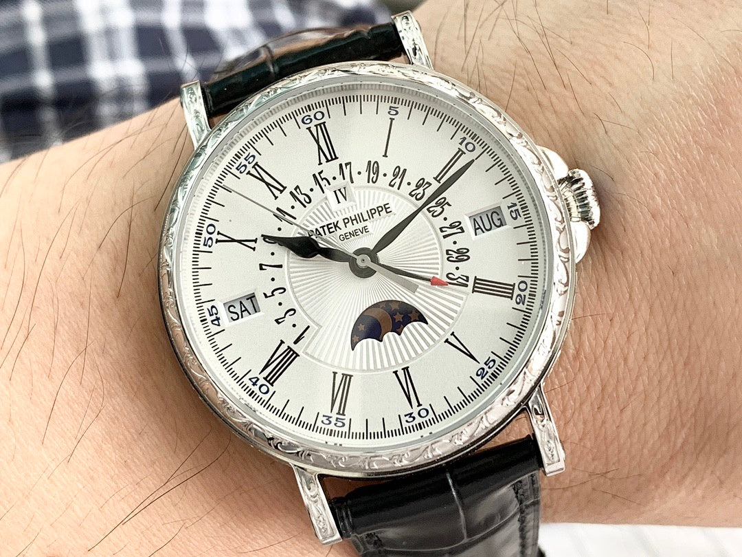 Luxury wristwatch on wrist with silver dial, Roman numerals, and black leather strap