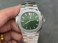Patek Philippe wristwatch with green dial, steel bracelet, and date window at 15