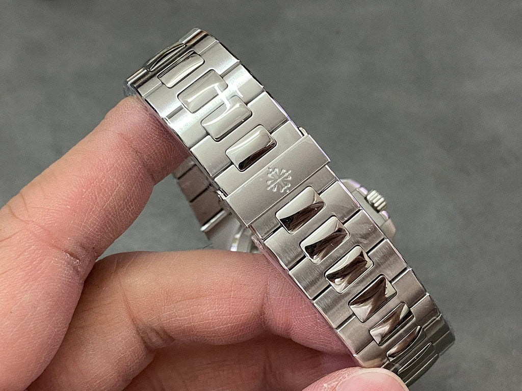 Stainless steel wristwatch bracelet detail with clasp and polished links